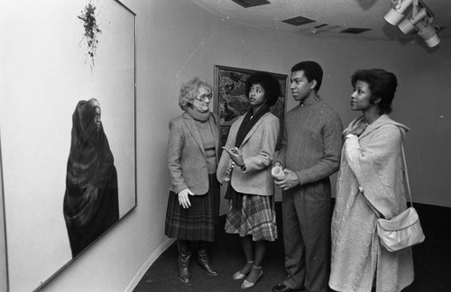 California African American Museum guests viewing a painting, Los Angeles, 1983