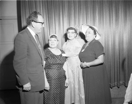 Three women pose with an unidentified man at event, Los Angeles