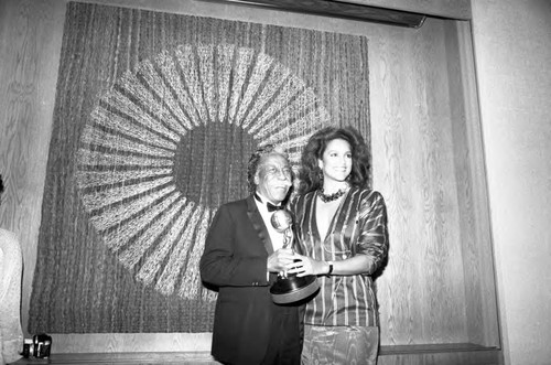 Gordon Parks receiving an award from Jayne Kennedy at the 17th Annual NAACP Image Awards, Los Angeles, 1984