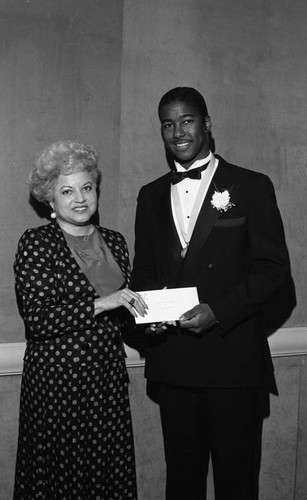 Young man in a tuxedo receiving an award, Los Angeles, 1987