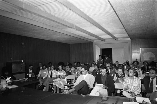 Meeting participants sitting together in a meeting room at Compton College, Compton, 1972