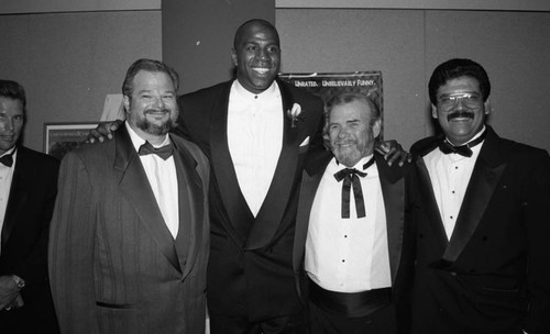 Magic Johnson posing with others during his "A Midsummer's Night Magic" event, Beverly Hills, 1994