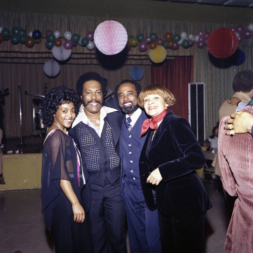 Herb and Connie Thompson posing with guests at their Super Bowl party, Los Angeles, 1977