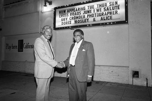 Guy Crowder posing in front of his celebration marqee, Los Angeles, 1987