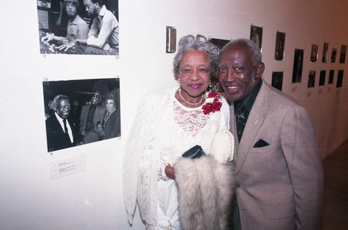 Guy Crowder exhibit guests posing near their photograph, Los Angeles, 1993