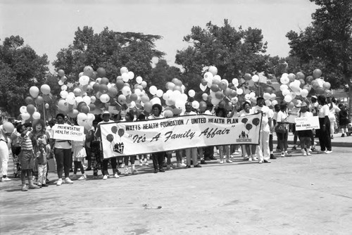 Black Family Reunion co-sponsors posing together at Exposition Park, Los Angeles, 1989