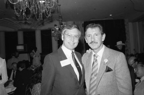 Beverly Hilton event guest Billy Martin posing with an unidentified man, Los Angeles, 1983