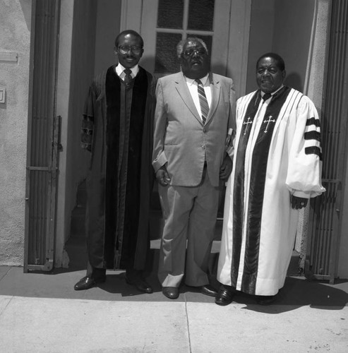 Members of the clergy posing together in a doorway, Los Angeles, 1983