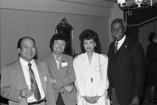 Nate Holden posing with Asian Americans at a special event, Los Angeles, ca, 1874