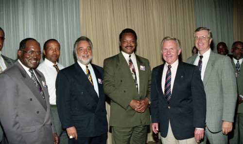 Rev. Jesse Jackson posing with others at a Tournament of Roses protest rally, Pasadena, 1993