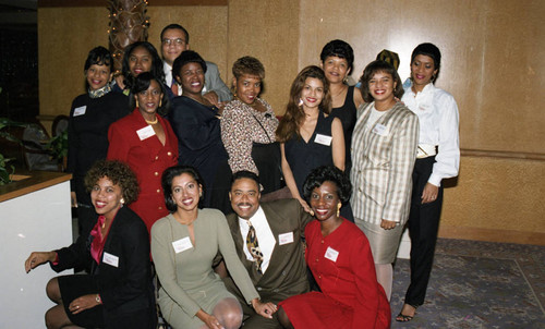 Atkins & Evans holiday party guests posing together, Los Angeles, 1994