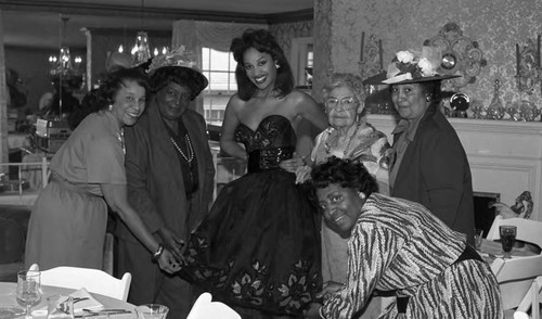 Angel City Dental Society Auxiliary members posing with a model, Los Angeles, 1989