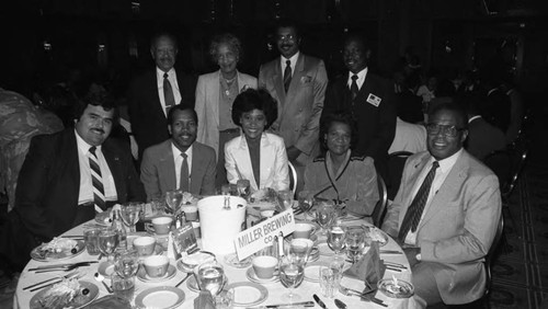 Miller Brewing Company representatives posing together during a Father's Day luncheon, Los Angeles, 1984