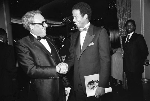 Benjamin Hooks and Michael Warren greeting each other at the NAACP Image Awards, Los Angeles, 1981