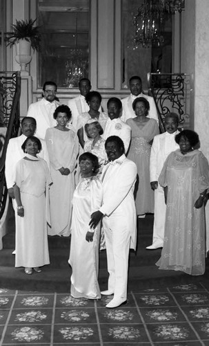 Cotillion attendees posing for a portrait on ballroom stairs, Los Angeles, 1986