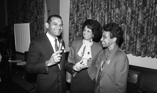 Billy Mills talking with two women, Los Angeles, 1986