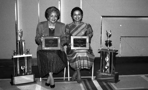 Juanita McNamee and Roberta Jones-Booker posing with their Los Angeles Alumnae Chapter, Delta Sigma Theta awards, Los Angeles, 1989