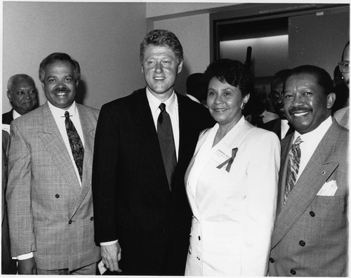 Bill Clinton posing with John Jacobs and others, 1992