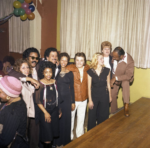 Connie Thompson posing with guests at her Super Bowl party, Los Angeles, 1977