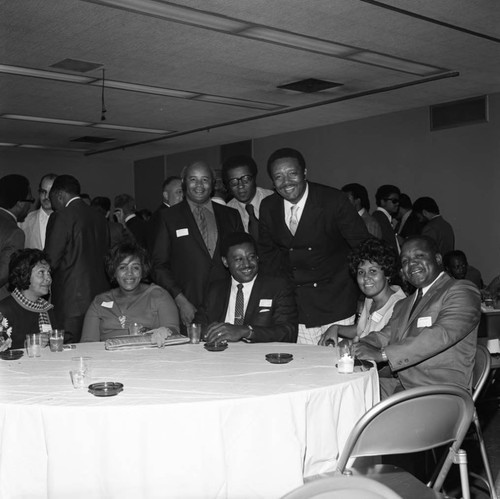 Guests of a Black media event posing together at the California Museum of Science and Industry, Los Angeles, 1970
