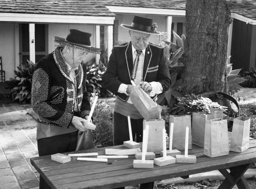 Men preparing luminarias, Los Angeles, 1983