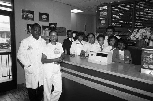 Chicken Charlie's restaurant owners and staff posing together, Los Angeles, 1987