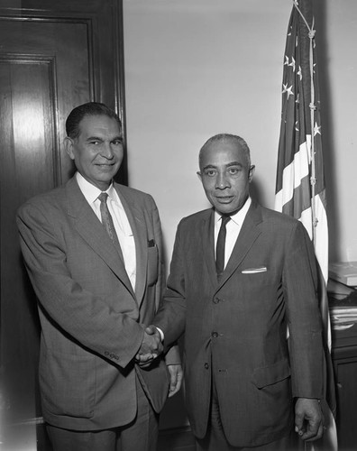 Lindsay shakes hands with man, Los Angeles, 1963