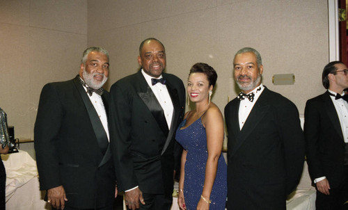 Deloria Jones and Victor M. Julien posing with others during the "A Midsummer's Night Magic" event, Beverly Hills, 1994