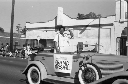 Grand Marshall of the 3rd annual Black History Parade waving to spectators, Los Angeles, 1986