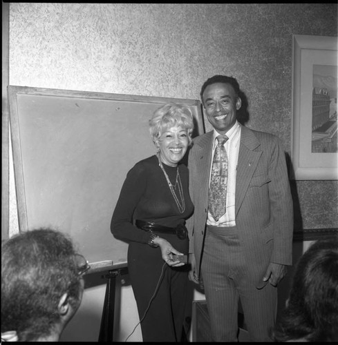 Arnett Hartsfield posing with a women during an A. Phillip Randolph Institute event, Los Angeles, 1973