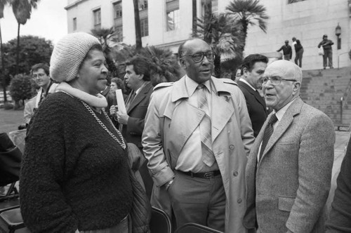 Mary B. Henry, Bishop H. H. Brookins, and Gus Hawkins talking in front of City Hall, Los Angeles, 1986