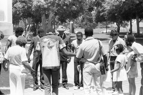 Rev. Bill Minson and others praying together near L.A. City Hall, Los Angeles, 1983