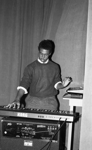 Young man playing a Korg keyboard at the California Museum of Science and Industry, Los Angeles, 1986