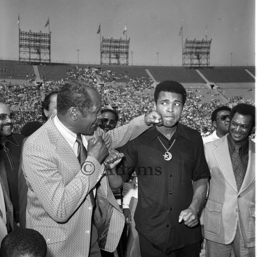 Tom Bradley throwing a playful punch at Muhammad Ali during the Freedom Football Classic, Los Angeles, 1973