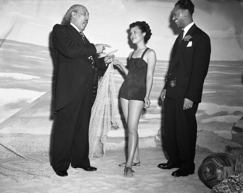 Bishop Charles M. Grace and Charles Williams talking with a model, Los Angeles, 1950