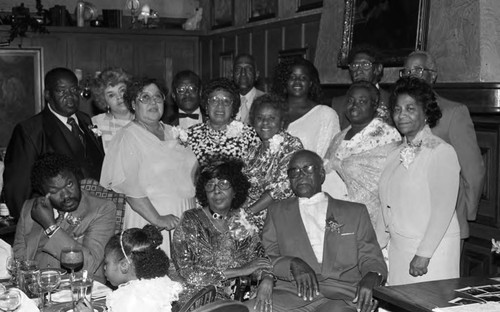 Mrs. Gloria Dupree posing with guests during a 50th anniversary dinner, Los Angeles, 1987