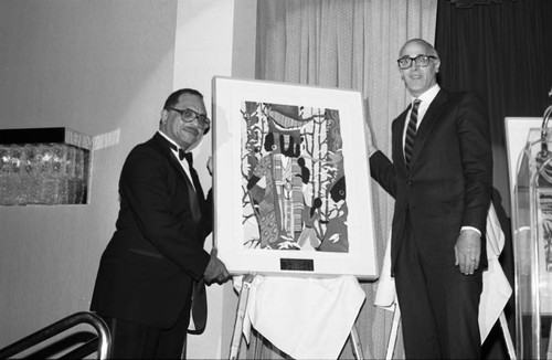 Dr. A. Palmer Reed receiving an award from Bill Honig, Los Angeles, 1987