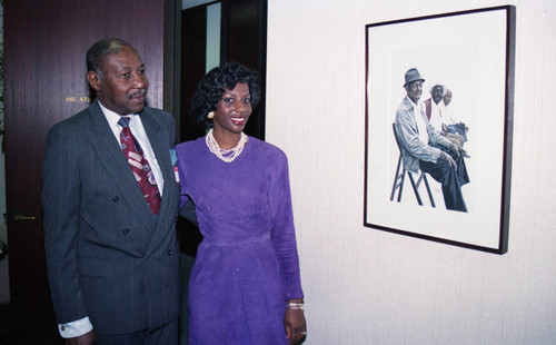 Atkins & Evans guests posing next to an art work, Los Angeles, 1994