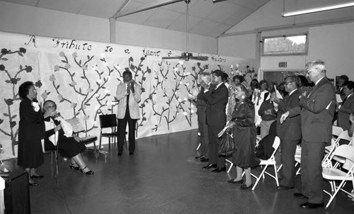 Rita Walters applauding with a crowd at the Estelle Van Meter Multipurpose Center, Los Angeles, 1989