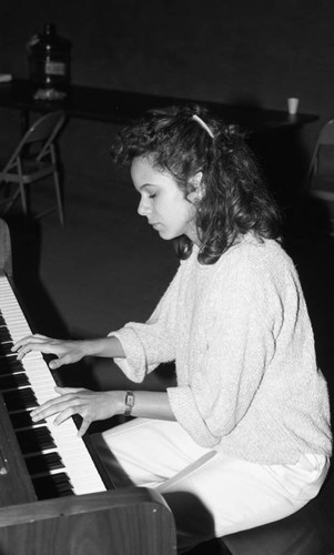 Young woman playing the piano at the California Museum of Science and Industry, Los Angeles, 1986