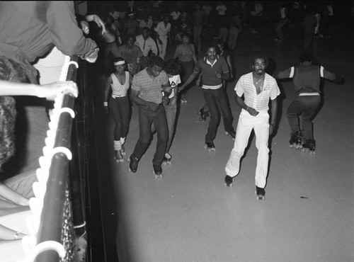 Men and women skating at World on Wheels, Los Angeles, 1983