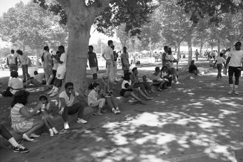 People eating in the shade at Exposition Park during the Black Family Reunion, Los Angeles, 1989