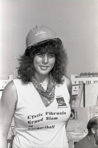 Women construction worker posing at a Community Redevelopment Agency project site, Los Angeles, 1981