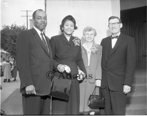 Couples stand outside building; Los Angeles, 1958