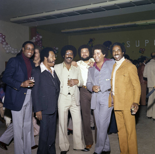 Donald Bohana posing with other guests at a Super Bowl party, Los Angeles, 1977