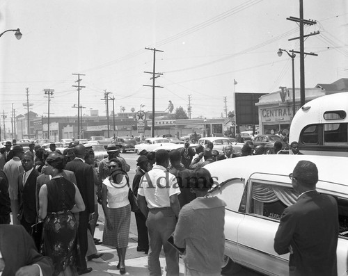 Crowd standing next to the hearse of Ronald Stokes, Los Angeles, 1962