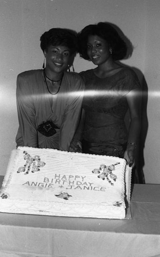 Janice Shields and a friend posing with a birthday cake, Los Angeles, ca. 1975