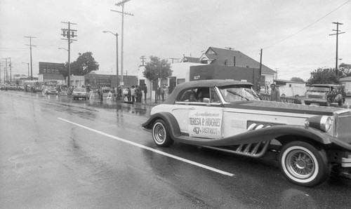 Teresa Hughes riding in a car past spectators during a South Central Easter Parade, Los Angeles 1982