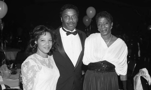 Man and two women posing together at a formal event, Los Angeles, 1987