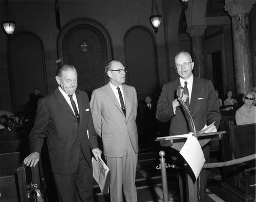 Three men at podium, Los Angeles